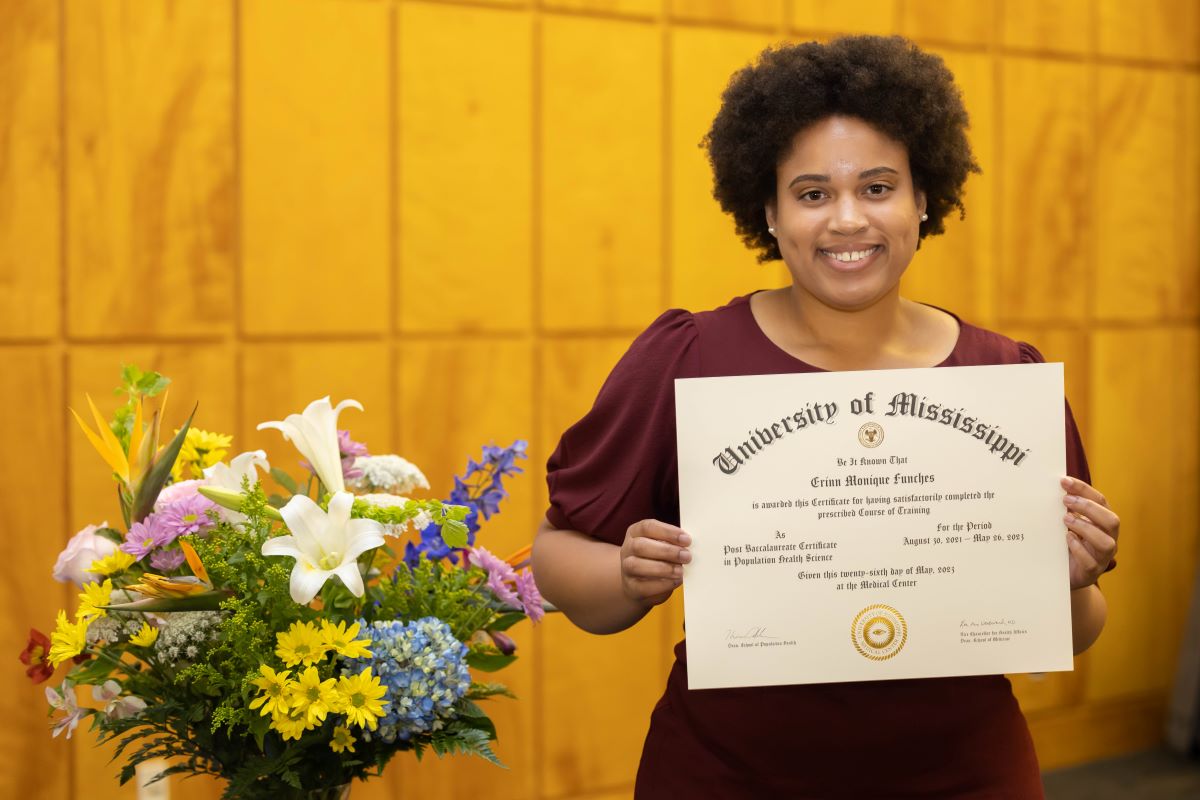 Student standing with certificate at the 2023 Honors and Awards Ceremony